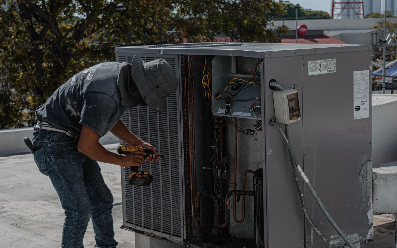 Technician repairing an outdoor air conditioning unit