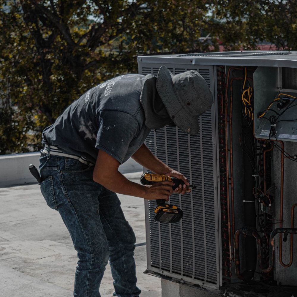 Technician servicing heating and cooling equipment